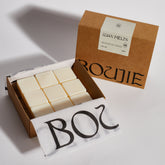 Boujie natural soy wax melts in eco-friendly open box packaging.
